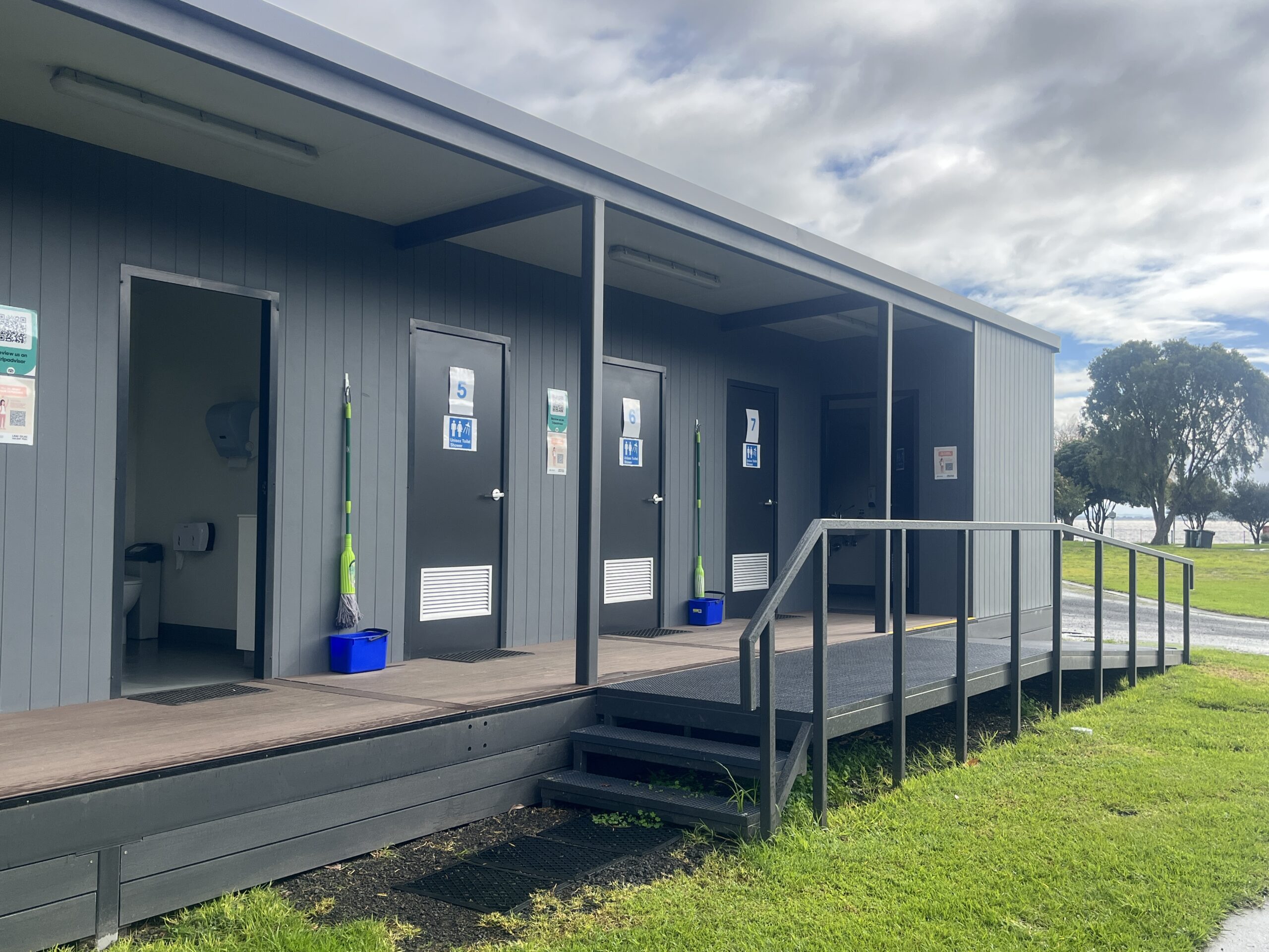 Access to shared amenities building includes a ramp with non-slip floors and handrails.